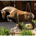 Heels Down Bronze jumping horse sculpture by Tammy Tappan standing 48" tall